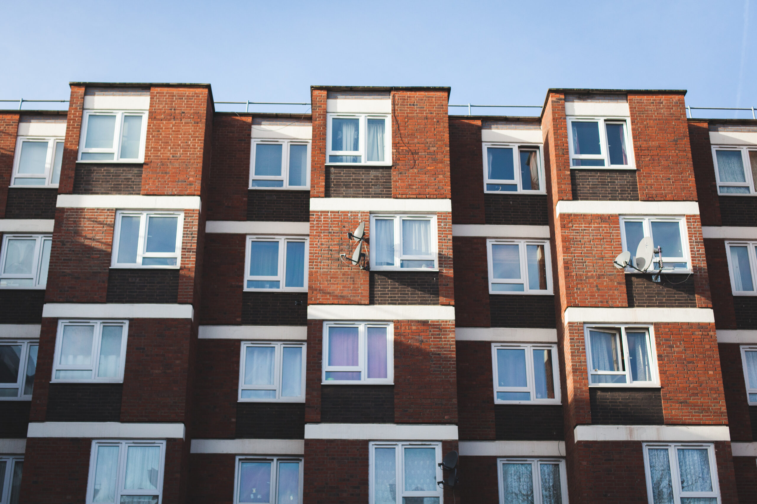 low-angle-view-building-against-sky-sunny-day-scaled